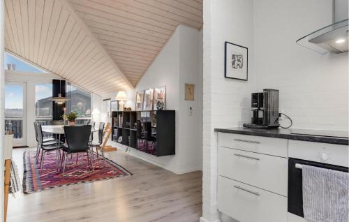 a kitchen and dining room with a table and a dining room at 4 Bedroom Lovely Home In Hirtshals in Hirtshals
