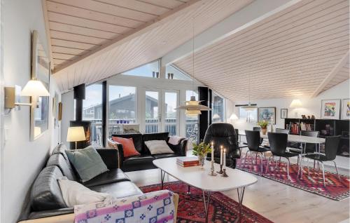 a living room with a couch and a table at 4 Bedroom Lovely Home In Hirtshals in Hirtshals