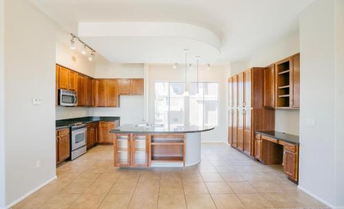 a kitchen with wooden cabinets and a island in it at Westgate 3 bedroom in Glendale