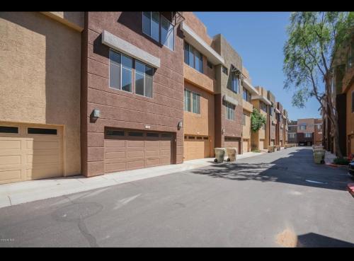 an empty street in front of a brick building at Westgate 3 bedroom in Glendale