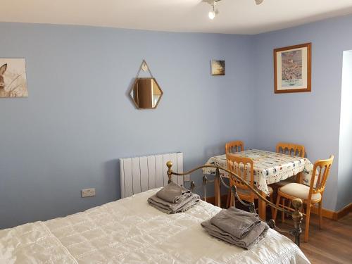 a bedroom with a bed and a table and chairs at 1 Bed Sleeps 2 Free Parking Pets Welcome in East Dereham