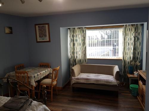 a bedroom with a bed and a window and a table at 1 Bed Sleeps 2 Free Parking Pets Welcome in East Dereham