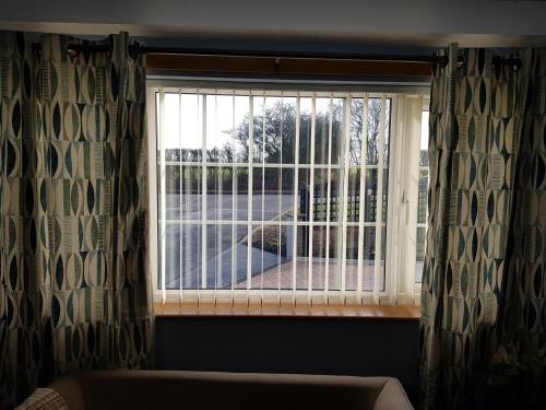 a window with a view of a balcony at 1 Bed Sleeps 2 Free Parking Pets Welcome in East Dereham