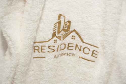 a white sweater with a residence america logo on it at Résidence America in Dakhla