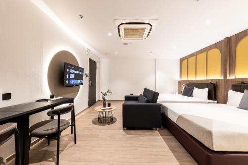a hotel room with a bed and a desk at Owen House by Habyt in Singapore