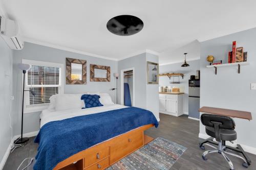 a bedroom with a bed and a desk and a chair at A Cottage - Walk to UC Davis & Shriners in Sacramento