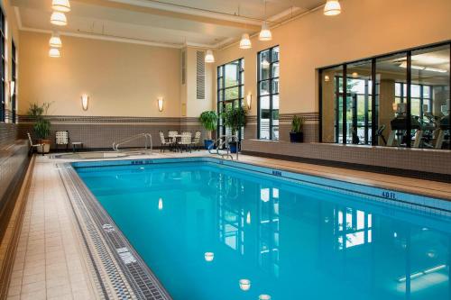 a large swimming pool with blue water in a hotel at Victoria Marriott Inner Harbour in Victoria