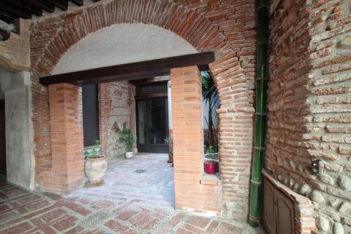 an entrance to a brick building with an archway at Studio en plein centre historique de perpignan in Perpignan