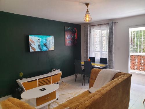 a living room with a couch and a table at Stellar 1-bedroom apartment in Madaraka Estate, Nairobi in Nairobi