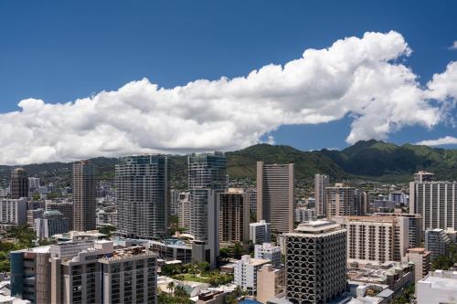 a view of a city with buildings and mountains at Sheraton Waikiki Beach Resort in Honolulu
