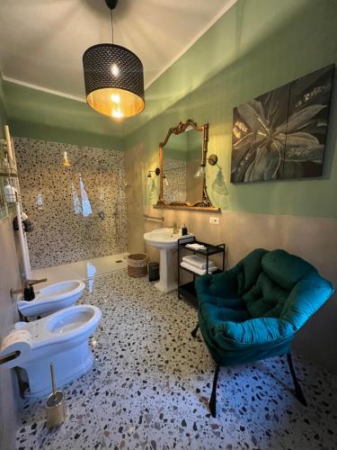 a bathroom with two toilets and a green couch at Borgo Marinaro Suite in Salerno