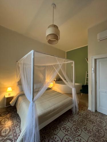 a bedroom with a bed with a canopy at Borgo Marinaro Suite in Salerno