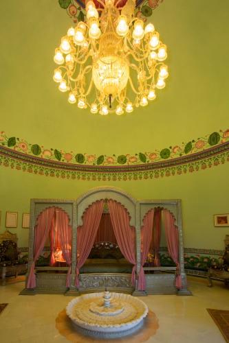 a large room with a chandelier and a table at Shiv Niwas Palace by HRH Group of Hotels in Udaipur