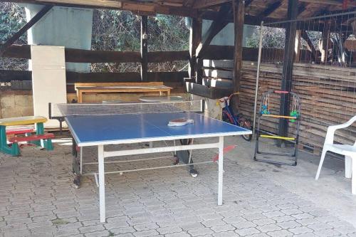 a ping pong table sitting inside of a pavilion with at Große tolle 4 Zimmer Ferienwohnung im Herzen des Odenwaldes in Mörlenbach