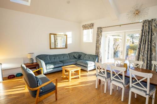 a living room with a couch and a table and chairs at The Kennelman 2 bedroom option in Alnwick