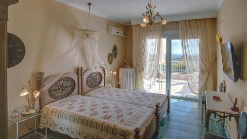 a bedroom with a bed and a balcony at Hotel Villa Sevasti in Katerini