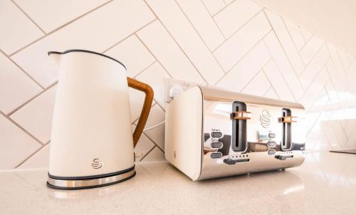 a toaster and toaster sitting on a counter at The Coach House in Alnwick