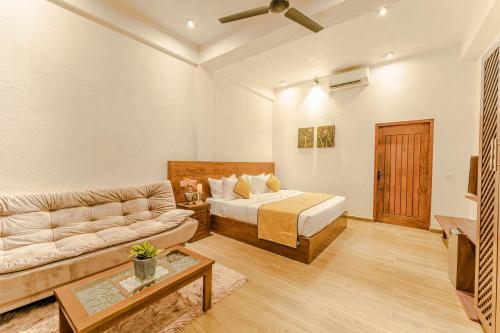 a living room with a bed and a couch at Kapaliya Unawatuna in Unawatuna