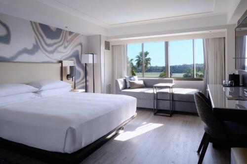 a bedroom with a large bed and a living room at Long Beach Marriott in Long Beach