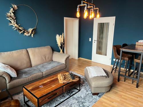 a living room with a couch and a table at Ferienwohnung "Charlotte" nahe der Elbe mit kostenlosem Parkplatz vor der Tür in Magdeburg
