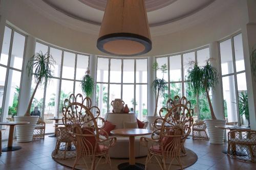 a room with tables and chairs and windows at Marina Smir Hotel & Spa in M'diq