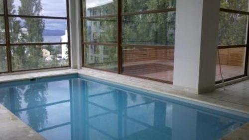 a swimming pool in a house with a window at Bariloche Downtown 2 in San Carlos de Bariloche