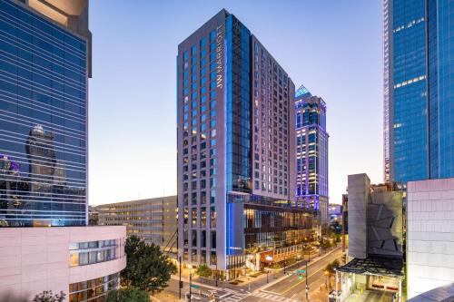a tall glass building in the middle of a city at JW Marriott Charlotte in Charlotte