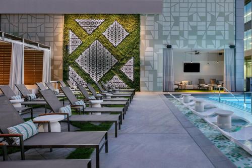 a hotel lobby with chairs and a swimming pool at JW Marriott Charlotte in Charlotte