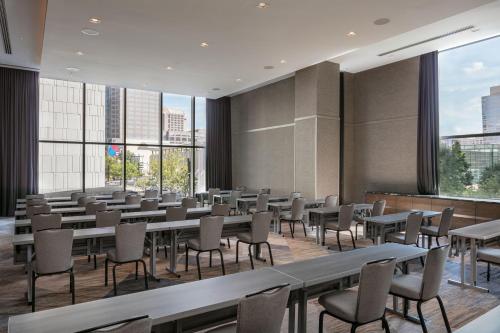 a large room with tables and chairs and windows at JW Marriott Charlotte in Charlotte