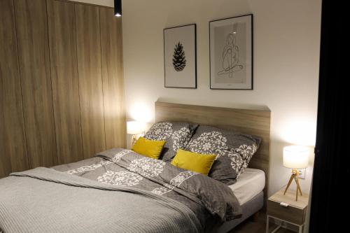 a bedroom with a bed and two pictures on the wall at O! Shellter Apartment LUXURY by Oskar in Rogowo