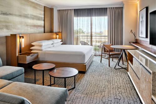a hotel room with a bed and a living room at JW Marriott Phoenix Desert Ridge Resort & Spa in Phoenix