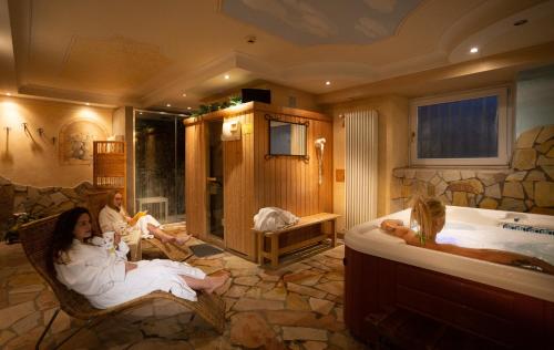 a group of people in a bathroom with a tub at Hotel Andalo in Andalo