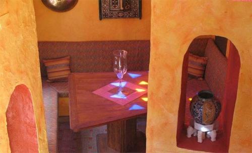 a room with a table with a wine glass on it at Hotel Amanhavis in Benahavís