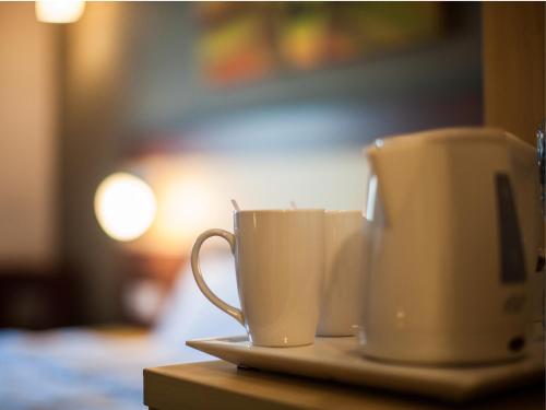 two coffee cups on a plate on a table at Citymax Hotel Bur Dubai in Dubai