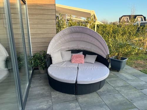 a circular bean bag chair sitting on a patio at Luxus Chalet Waterfront in Lathum