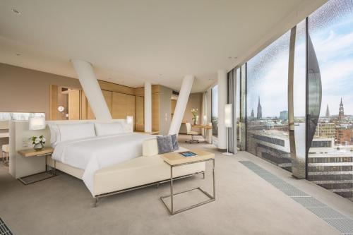 a bedroom with a white bed and a large window at The Westin Hamburg in Hamburg