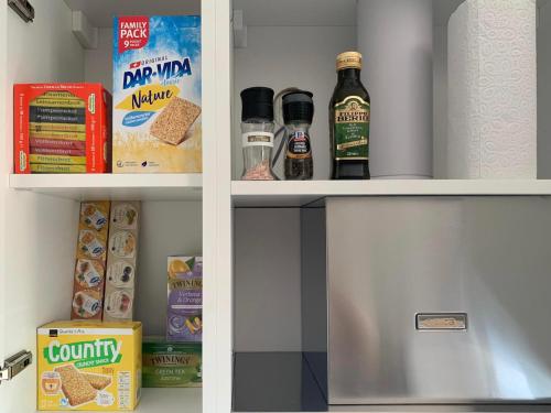 a refrigerator with some food and drinks in it at Live Lugano - Via A Riva in Lugano