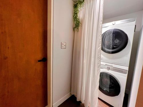 a laundry room with a washer and a washing machine at HHZib, homestay on a hill in the heart of Seoul - 'BEST SEOUL STAY 2024-25' by Seoul in Seoul