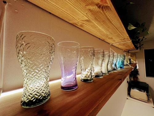 a row of glass vases sitting on a counter at HHZib, homestay on a hill in the heart of Seoul in Seoul