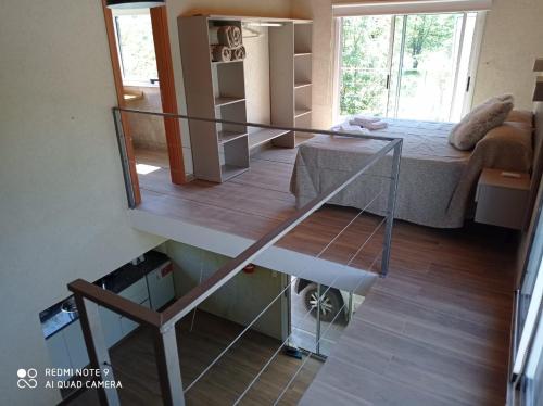 a small room with a bed and a staircase at DelViento Cabañas in Las Rabonas