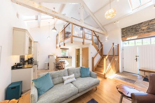 a living room with a couch and a kitchen at Mill Pool Barn Torver, Coniston in Coniston
