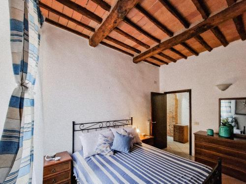 a bedroom with a bed and a wooden ceiling at Casa Veronica Rio Marina in Rio Marina