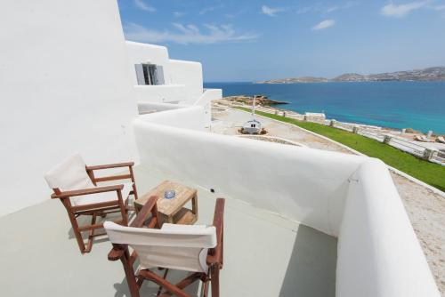 a balcony with chairs and a view of the ocean at Paros Bay in Parasporos