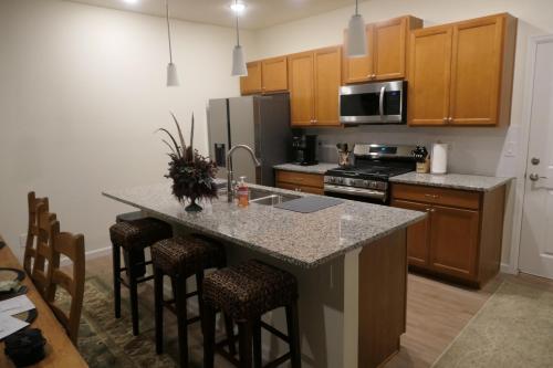 a kitchen with a large island with bar stools at Well Appointed 3-Bedroom Townhome in Colorado Springs
