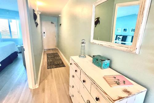 a dresser with a mirror on top of it in a bedroom at Perdido Sky 72 in Perdido Key