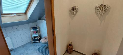 a bathroom with a toilet and a door with hearts on the wall at Große tolle 4 Zimmer Ferienwohnung im Herzen des Odenwaldes in Mörlenbach