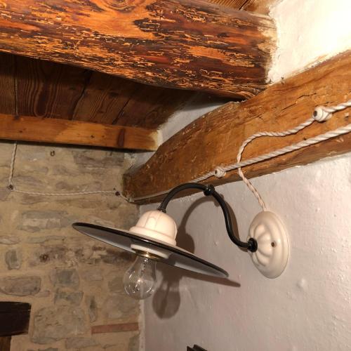 a lamp hanging from a ceiling in a room at CASA ANGELA Stayerat a SEGUSINO Valdobbiadene in Segusino