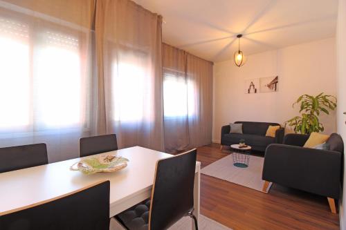 a living room with a table and a couch at Laranjal Guesthouse in Vila do Conde