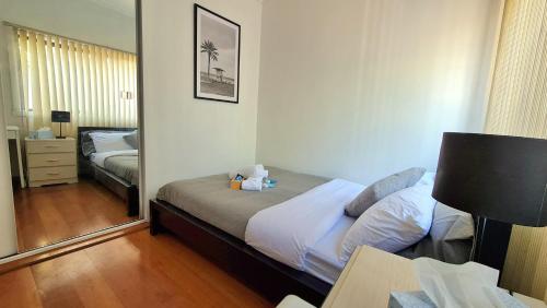 a bedroom with a bed and a mirror at Cosy room close to Melb Airport in Melbourne