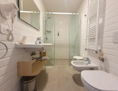a bathroom with a sink and a toilet and a shower at Casa Immacolata in Verbania